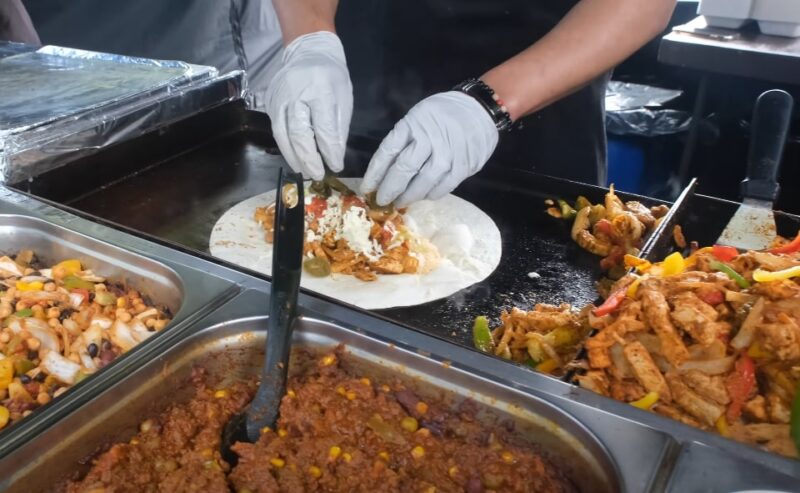 Preparing a burrito at a street food stand in Albuquerque