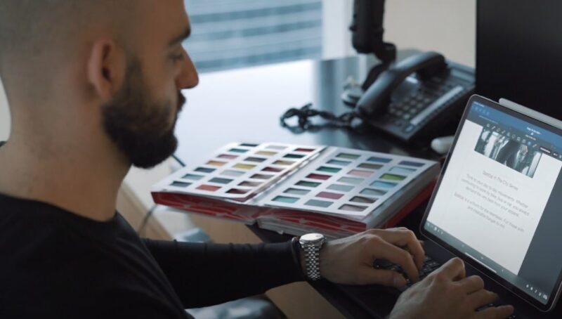 A designer selecting colors for a new collection while using laptop