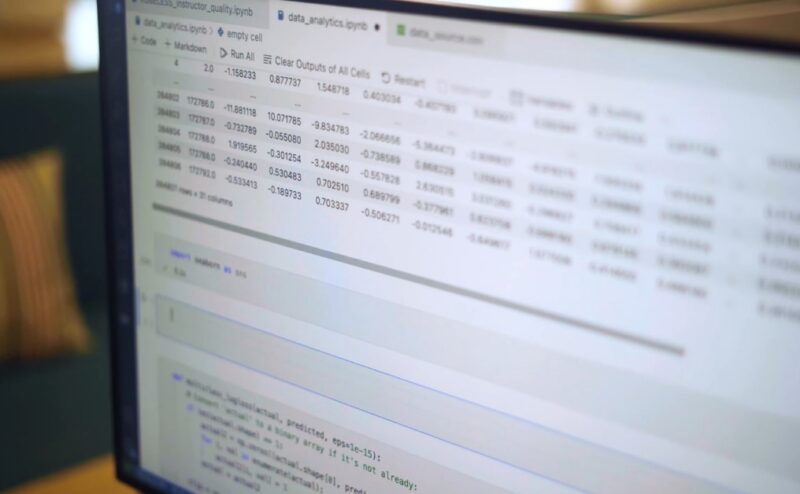 A computer monitor displays a complex data set, likely the output of a data analysis program