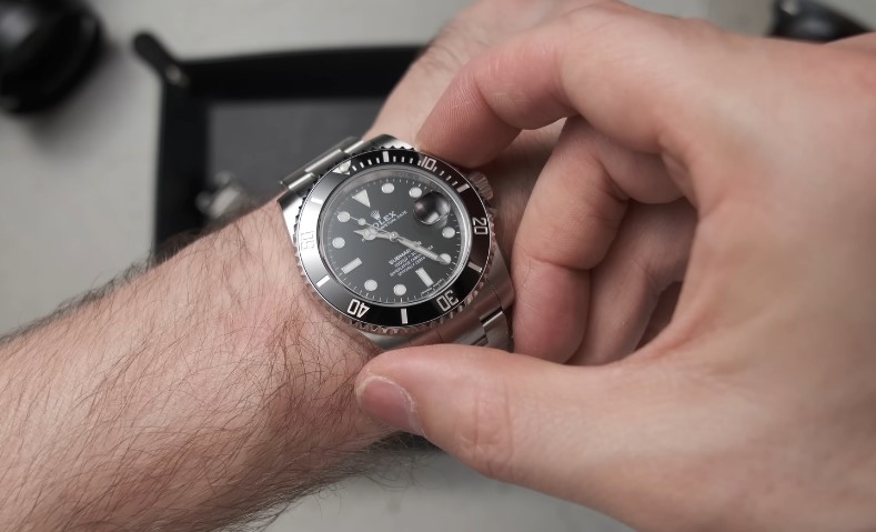 A close-up view of a Rolex Submariner watch on a wrist